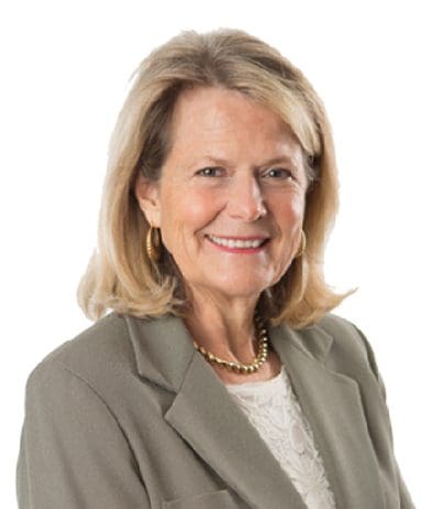 A woman with blonde hair and wearing a jacket.